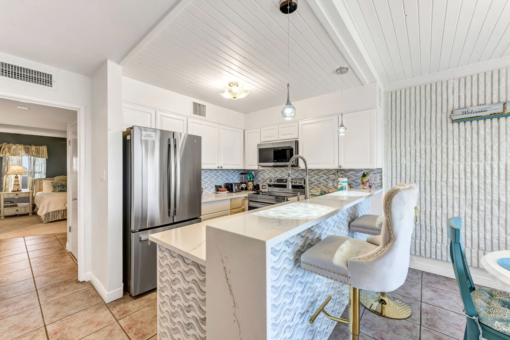Remodeled kitchen with quartz waterfall island